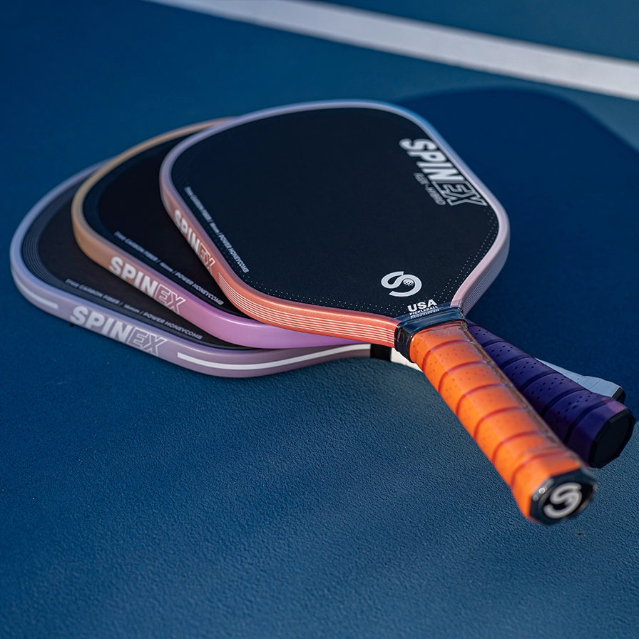 Spinex pickleball paddles on a blue surface