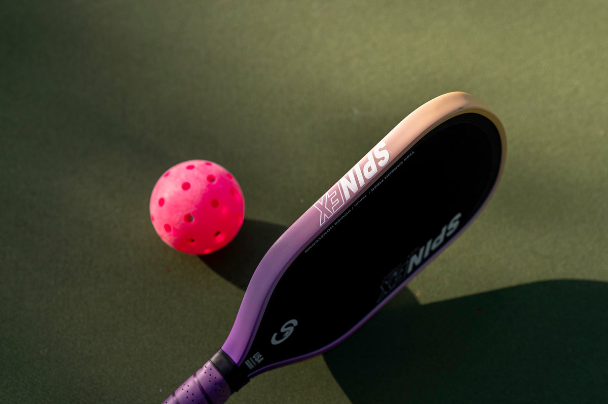 Spinex FLEX Hybrid pickleball paddle with a ball on court
